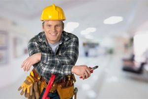 Electrician smiling with electric tools