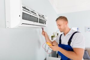 Electrician repairing AC in home at Frederick, MD