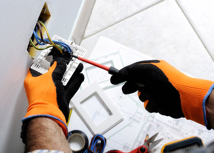 electrician's hands installing something