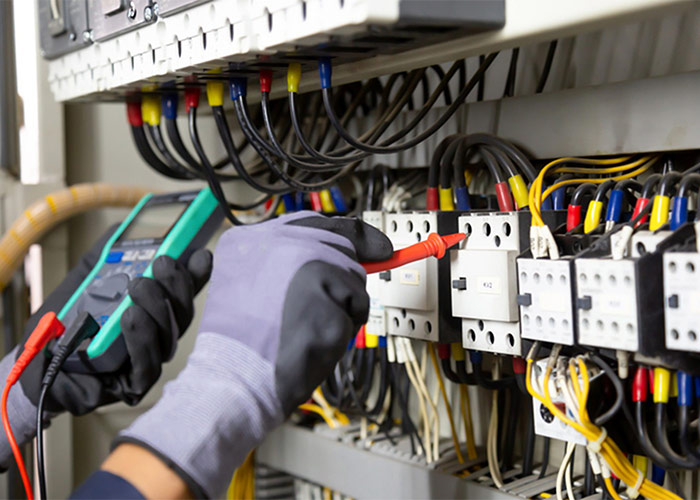 A Technician measuring Electric Current Highlighting Electrical Repairs in Frederick, MD
