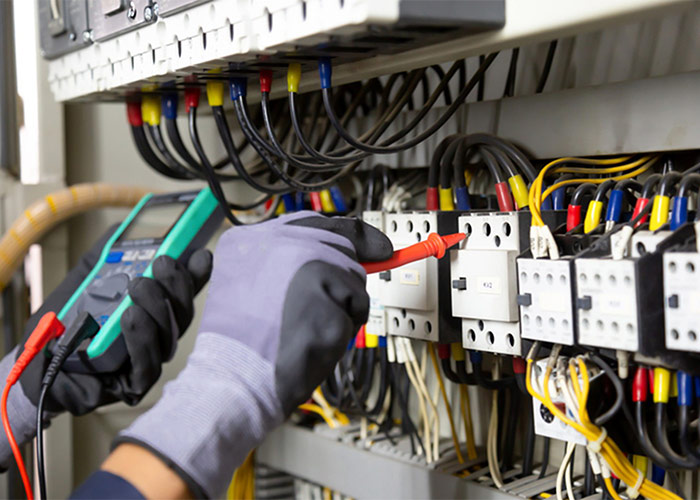 The person doing electrician measuring electric current in house 