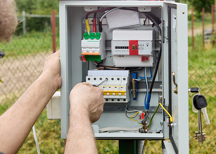worker repairing electrical device
