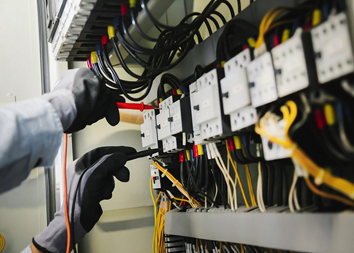 worker repairing electrical device