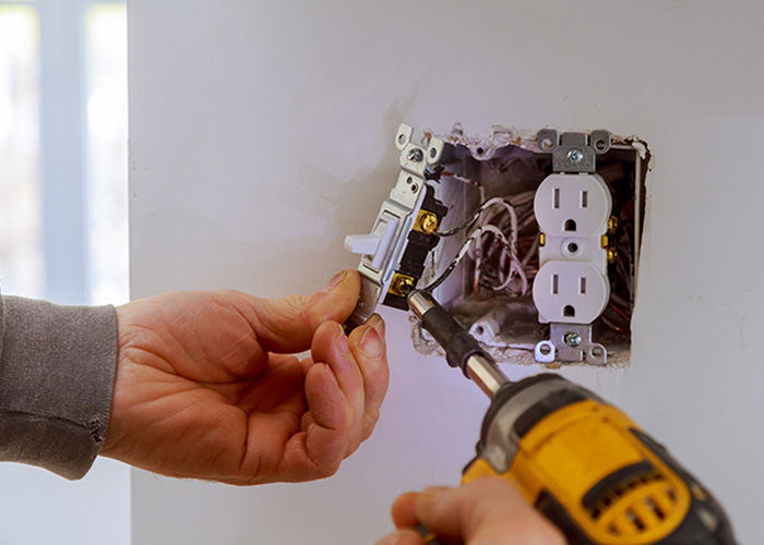 worker repairing electrical device