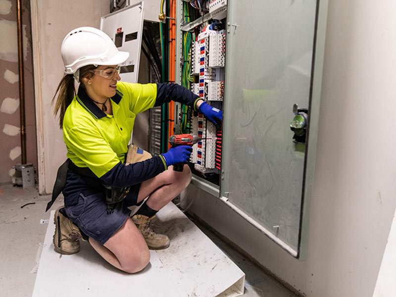 worker repairing electrical device