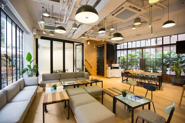 A modern office featuring ample seating and tables, illuminated by commercial lighting in Frederick, MD
